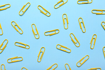 Yellow paper clips on blue background