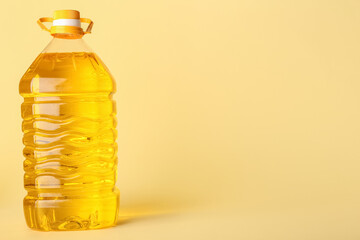 Big bottle of sunflower oil on color background