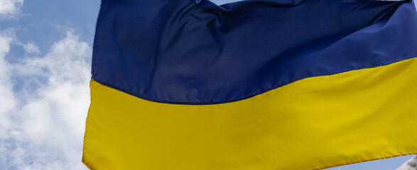 Ukraine flag isolated on the blue sky with clipping path. close up waving flag of Ukraine. flag symbols of Ukraine