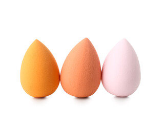 Colorful makeup sponges on white background