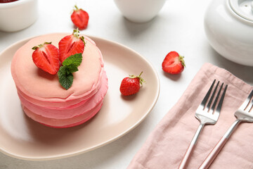 Plate of tasty pancakes with strawberry on table