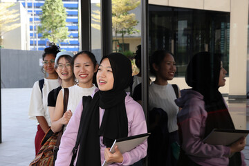 Four young attractive Asian group woman friends colleagues students outdoor building rooftop garden...