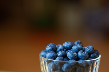 blueberries in a vase on a wooden table. Sweet dessert.
