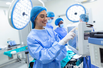 Anesthesiologist keeping track of vital functions of the body during cardiac surgery. Surgeon...
