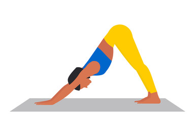 A young beautiful woman in sportswear is doing yoga on a mat in the Downward Facing Dog asana. Taking care of your physical health. Adho Mukha Svanasana. 