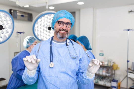 Portrait of male surgeon standing in operating room, ready to work on a patient. Male medical worker surgical uniform in operation theater.