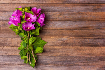 a bouquet of hibiscus flowers on a vintage wooden background with copy space