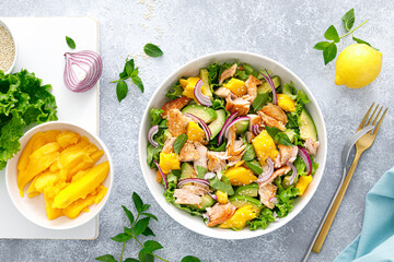 Grilled salmon and mango salad with avocado and fresh green lettuce