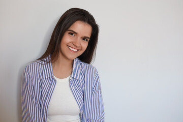 Portrait of beautiful young woman on white background, space for text