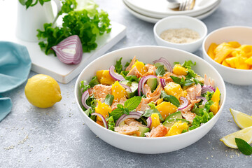 Grilled salmon and mango salad with avocado and fresh green lettuce