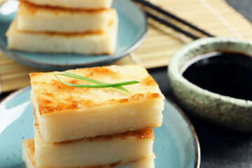 Delicious turnip cake with herb on plate, closeup