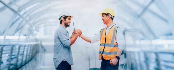 Engineer construction workers shaking hands with deals on construction site, success collaboration...