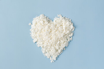 Heart from coconut or organic soy wax flakes. Heap of  Soy wax for candlemaker. Flatlay, top view....