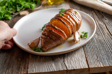 Healthy potato side dish with a oven baked sweet potato. cooked with garlic, herbs and olive oil