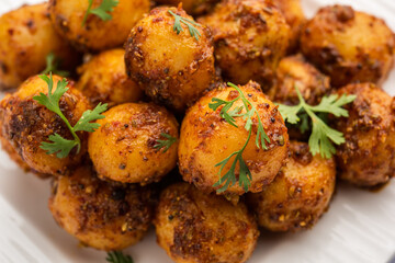 Homemade Roasted Bombay potatoes. Pan fried little baby potatoes or aloo with jeera seeds and coriander in bowl