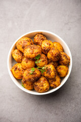 Homemade Roasted Bombay potatoes. Pan fried little baby potatoes or aloo with jeera seeds and coriander in bowl