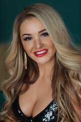 Fototapeta premium a beautiful sexy woman. attractive young female in the black dress is smilling and relaxing