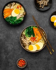 Asian Style Noodles Soup with Mushrooms, eggs, dan Assorted Vegetables on the dark background.