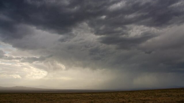Timelapse of dark desert rainstorm moving over the desert in Utah.