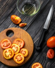 Fototapeta na wymiar Fresh Tomato Slices on wooden table and cutting board