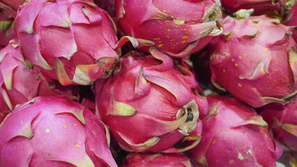 Stack of fresh dragon fruit for sale in a farmers market