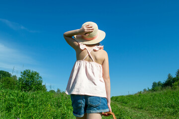 Little cute girl in the hat close-up portrait outdoors. The concept of a happy childhood. High quality photo