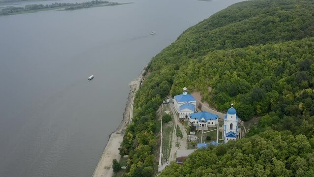 Makaryevsky men Monastery on the banks of the Sviyaga and the Volga River. Christianity and Orthodoxy. A picturesque peaceful place on the water. Forest hills. Pilgrimage and Diocese. Drone footage. 