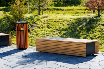 A wooden bench in the city park, a modern design of a recreation place for citizens, a round-shaped...