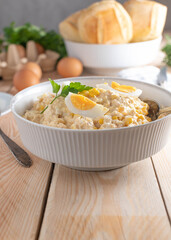 Tuna salad with mayonnaise, boiled eggs and corn in a bowl