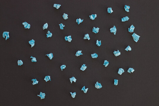 Blue crumpled paper on black background. New idea.