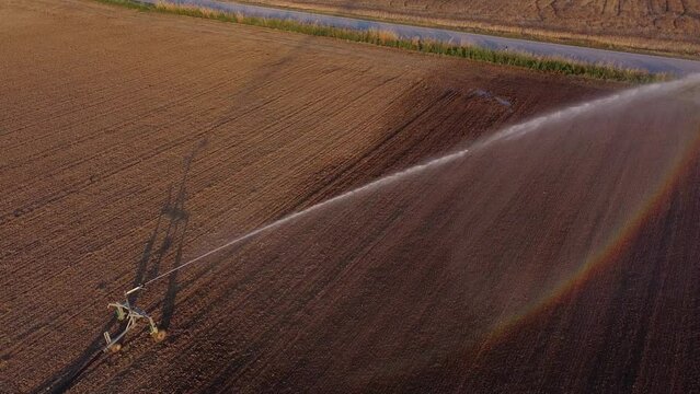Aerial View of irrigation in Brown Agricultural Land Soil, Watering Equipment in Farm Field in Cingoli, Macerata Italy