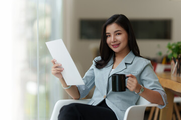 Portrait of Asian Business woman with coffee at morning at home. Account and Finance concept.