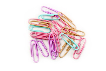 Multicolored paper clips close up isolated on white background. Stationery concept.
