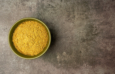Coriander Powder from a flatlay angle with a dramatic dark background.