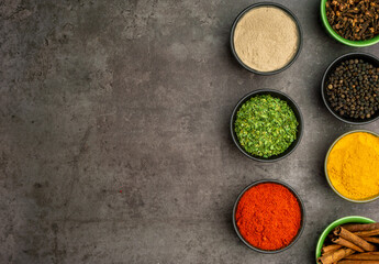 High quality photo of various spices with a dramatic concept on a dark background.