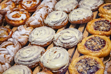 Tasty cakes and rolls are laid out on a show-window in baicary