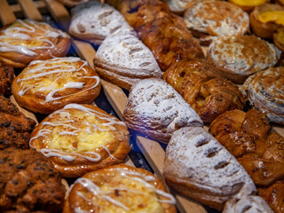 Tasty cakes and rolls are laid out on a show-window in baicary