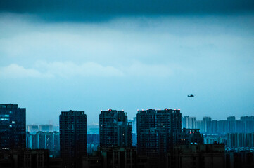 helicopter and clouds over city