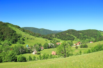 Mountain village in green landscape. Panoramic view. Begovo razdolje in Gorski kotar area, Croatia.