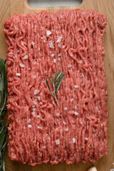 Raw mince beef, ground meat. Black background. Top view. Copy space