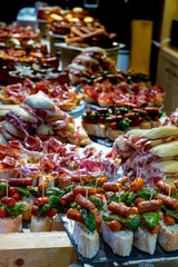 Fotobehang Typical snack of Basque Country and Navarre, pinchos or pinxtos, small piece of bread with different toppings, served in bar, Bilbao, Spain © barmalini