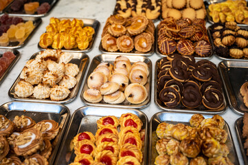 Variety of cookies and cakes on display in artisanal bakery in San Sebastian city, Basque Country, Spain