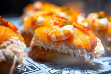 Typical snack of Basque Country and Navarre, pinchos or pinxtos served in bar, small slices of bread upon which ingredient or mixture of ingredients is placed, San Sebastian, Spain