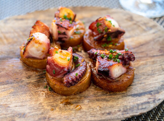 Spanish starter in fish restaurant in Getaria, grilled octopus with roasted potatoes and paprika, Basque Country, Spain