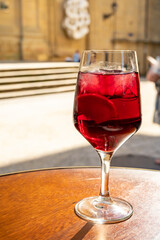 Glass of cold sangria wine served outdoor in bar with view on old street in San Sebastian, Basque Country, Spain