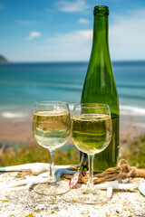 Tasting of txakoli or chacolí slightly sparkling very dry white wine produced in the Spanish Basque Country, served outdoor with view on Bay of Biscay, Atlantic Ocean.