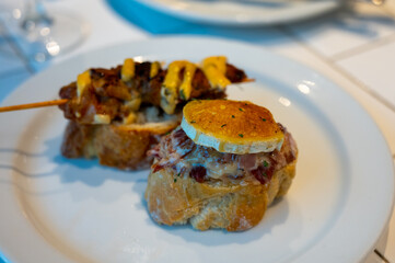 Typical snack of Basque Country and Navarre, pinchos or pinxtos, small piece of bread with different toppings, served in bar, Bilbao, Spain