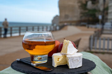 Tastes of Normandy - french cheese camembert and apple cider served in cafe on promenade of Etretat...
