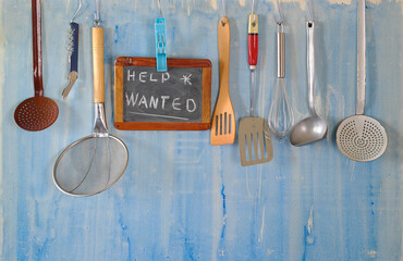 Help wanted sign,restaurant or cafe looking for staff after corona lockdown, kitchen utensils and job posting on blackboard