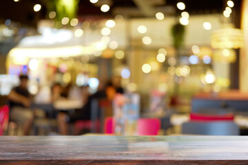 Empty wooden table against blurred night market background. Copy space for display or montage your products
